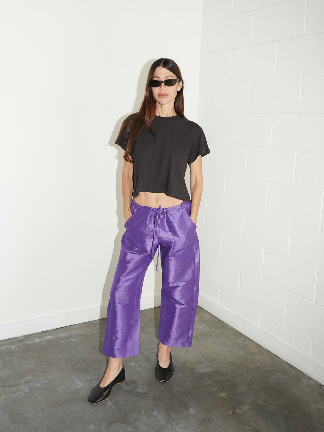 Full body shot of purple satin pants paired with a black t-shirt.
