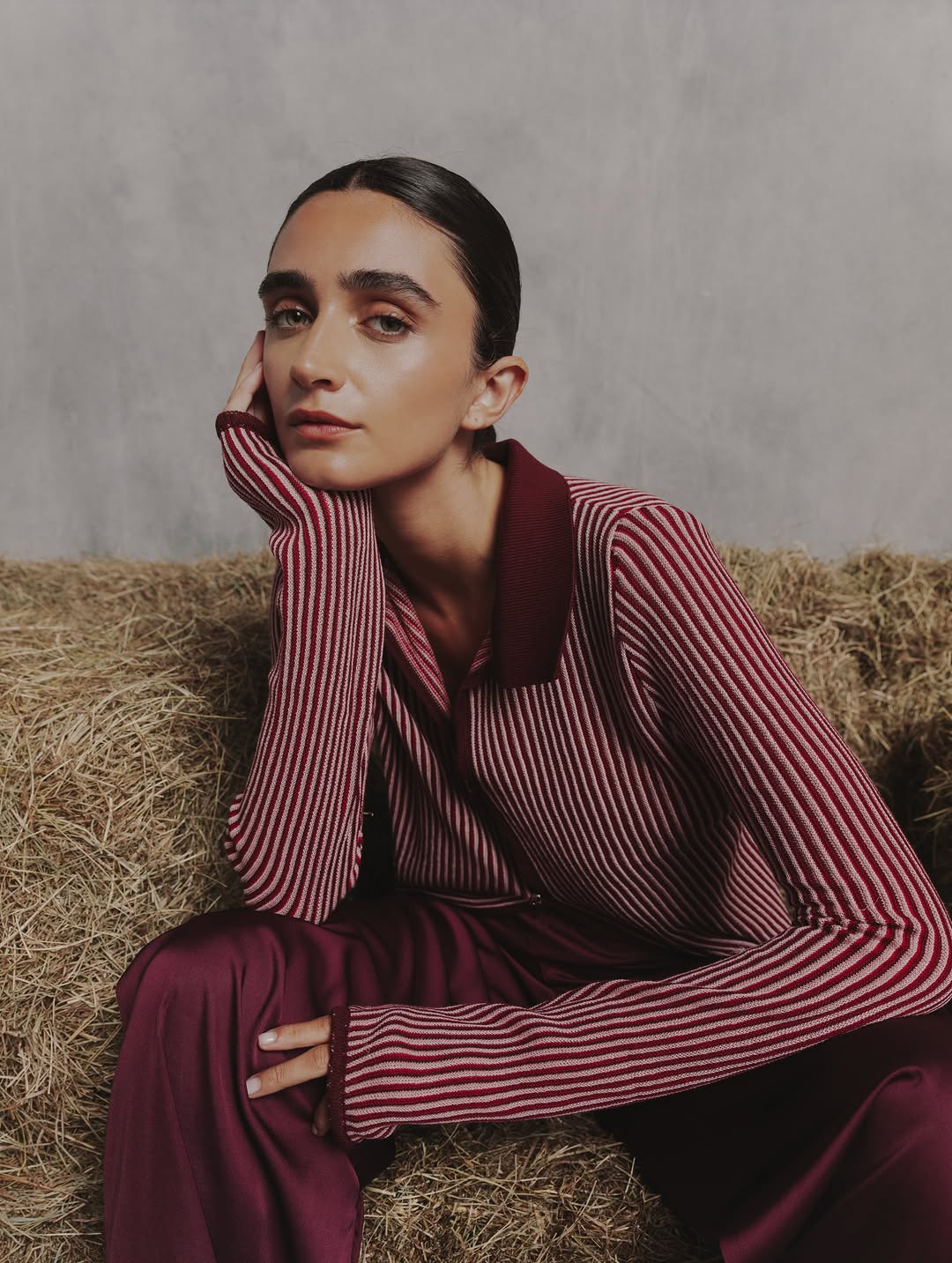 Close-up portrait highlighting the details of the striped shirt's collar and fabric texture.