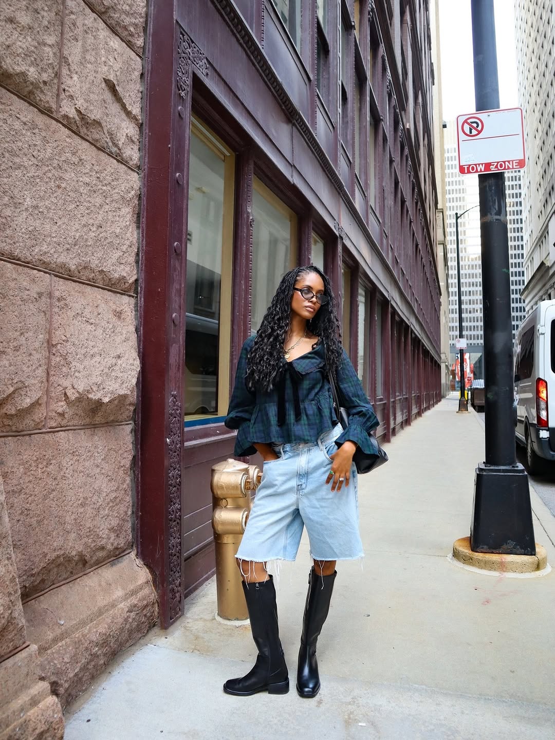 Frontal view of the coordinated outfit featuring the plaid top with bow detail and frayed denim shorts.
