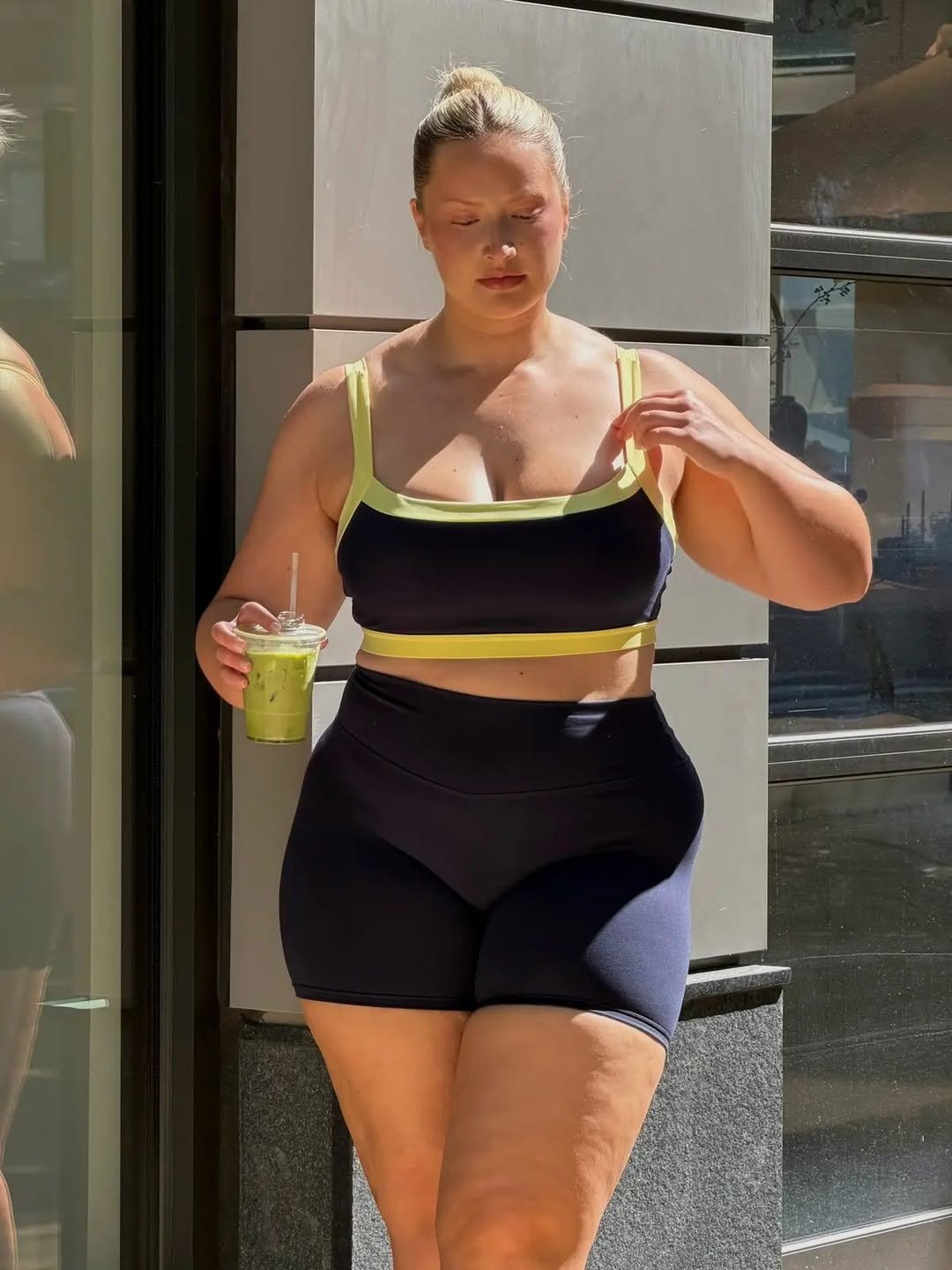 Walking shot displaying the side profile of the bra and shorts.