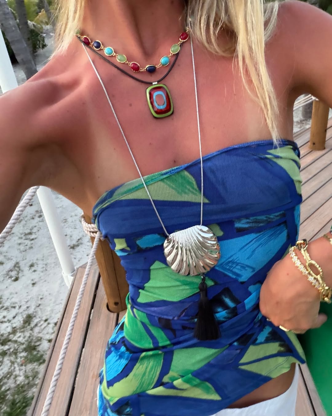 A close-up selfie angle showing the details of the blue and green printed fabric wrapped as a bandeau top.