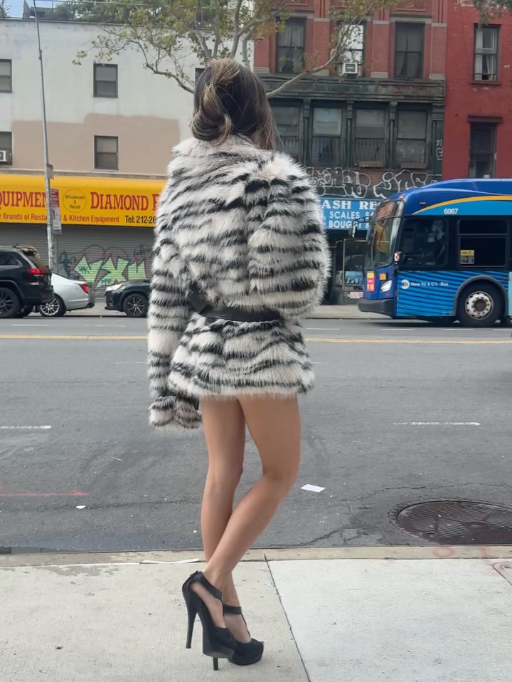Another rear angle on the street highlighting the fit and length of the striped faux fur coat.