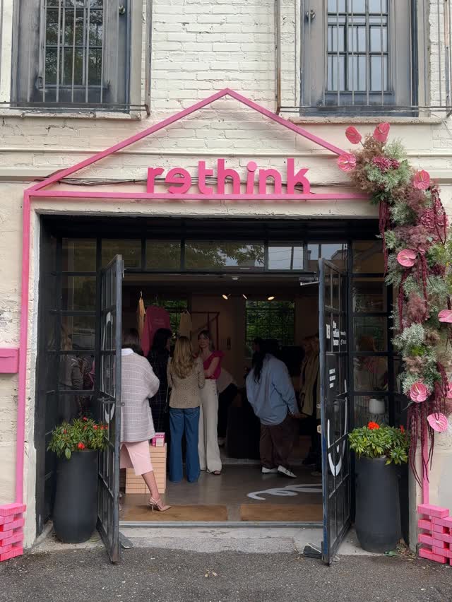 Exterior view of the 'rethink' pop-up shop entrance with people inside.