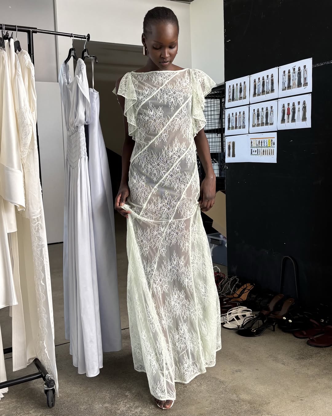 Full-length view of the model walking in the identical lace gown.